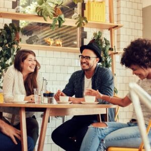 A group of people sitting at a table with drinks.