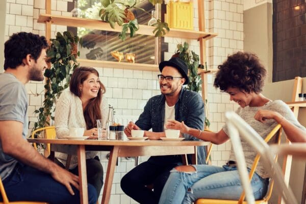 A group of people sitting at a table with drinks.