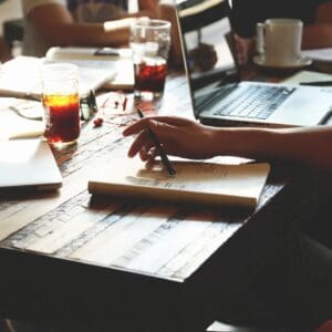 A-small-group-of-team-members-on-a-small-business-team-brainstorm-and-discuss-strategy-about-how-to-grow-their-leadership-skills-as-part-of-a-training-in-Hendersonville-NC.