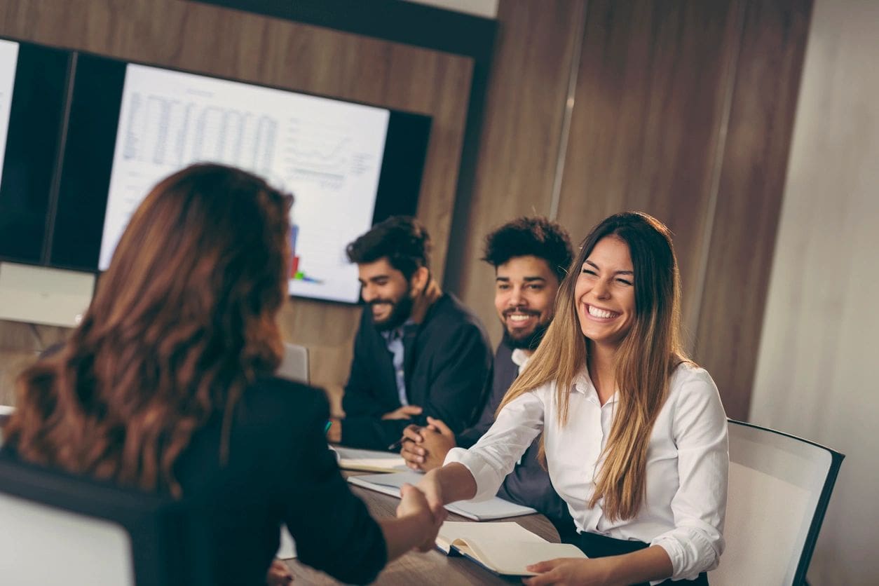 A group of people sitting around a table.