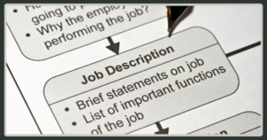 A close-up shot of a printed "Job Description" document with bullet points detailing job statements and important functions.