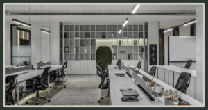 A wide, symmetrical view of a sleek, minimalist open-plan office with white desks, ergonomic black chairs, and a large architectural bookshelf.